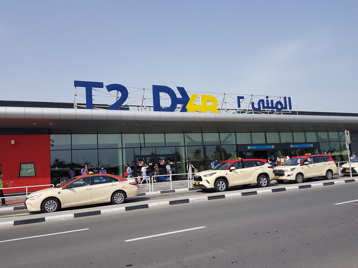 Dubai International Airport terminal with clear lines of passengers and cargo trucks