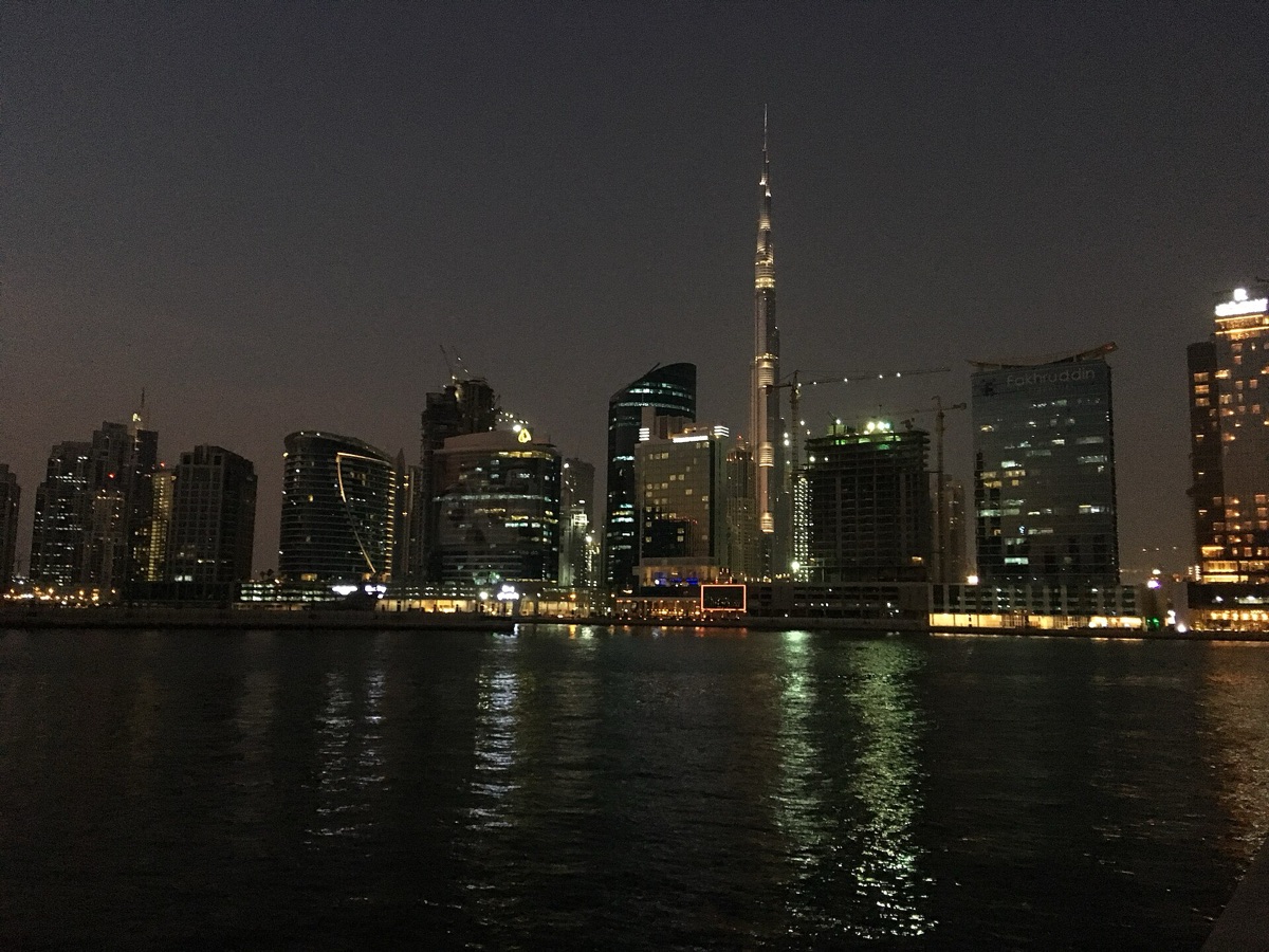 Dubai skyline at night with glowing buildings and a clear sky